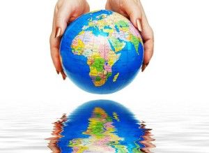 two hands holding a globe isolated on white